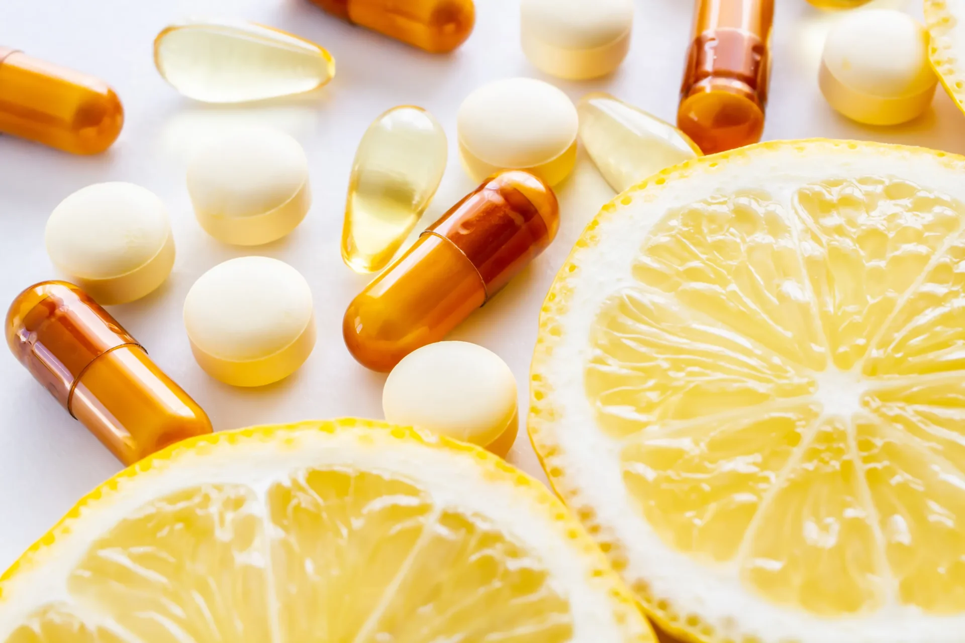 Lemon slices and assorted vitamin pills.