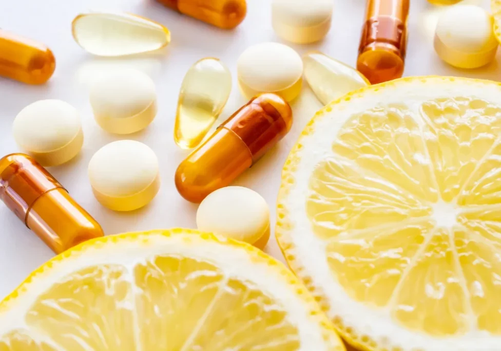 Lemon slices and assorted vitamin pills.